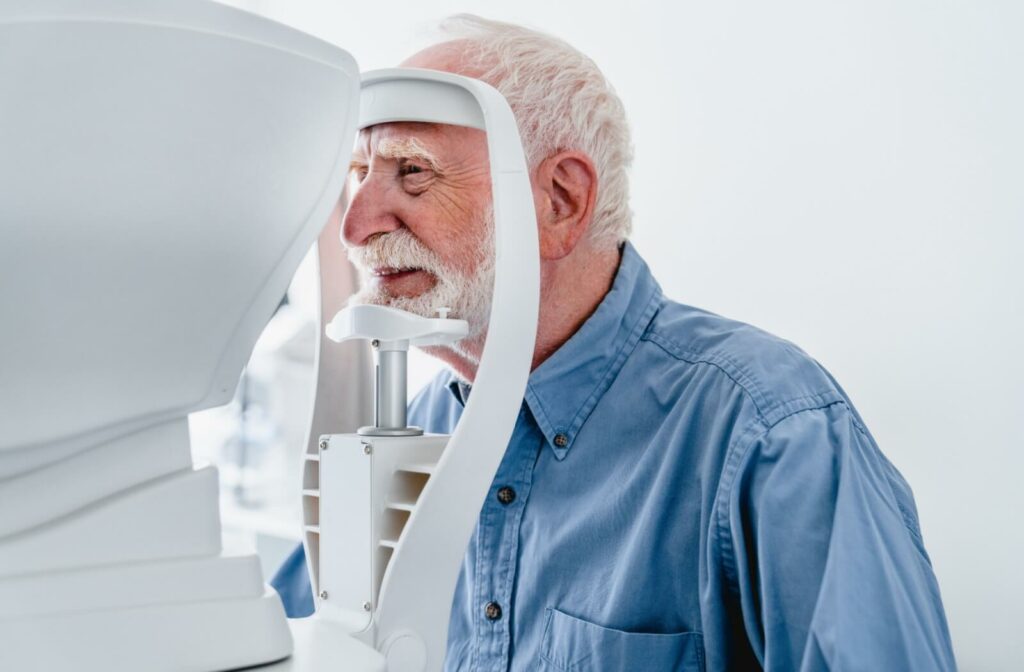 A smiling older adult undergoing testing during a routine eye exam.