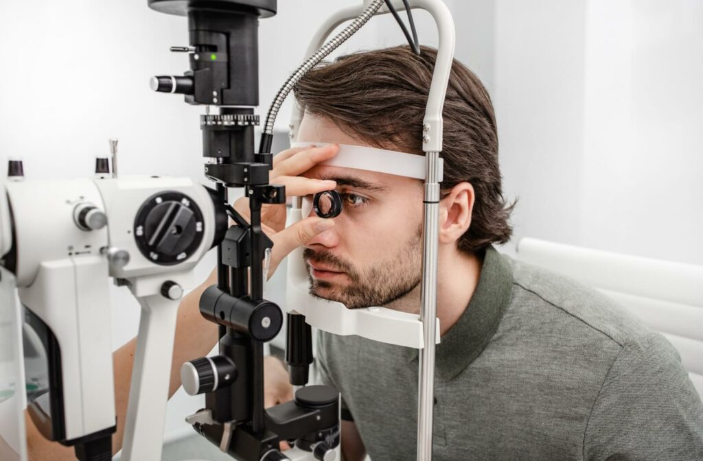 An adult with a lazy eye getting their eyes examined to monitor their progression.